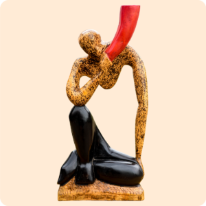 A Carved Sculpture Of A Horn Blower