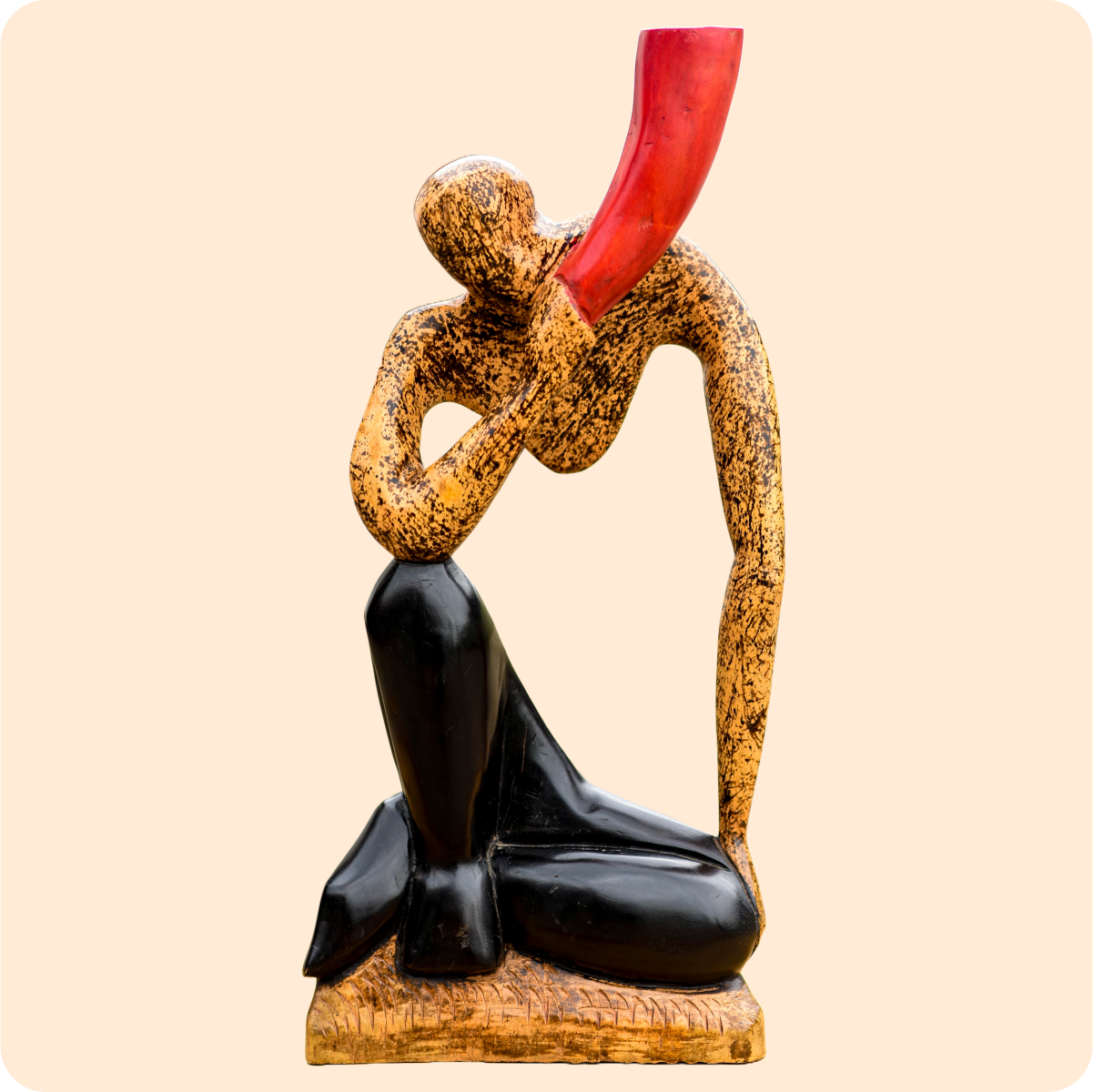 A Carved Sculpture Of A Horn Blower