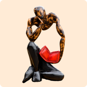 Carved Sculpture Of A Thinking Man With Book